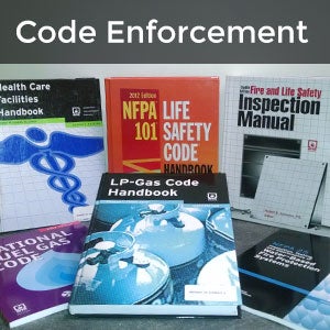 Code Enforcement - books on desk